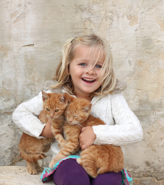 child with kittens